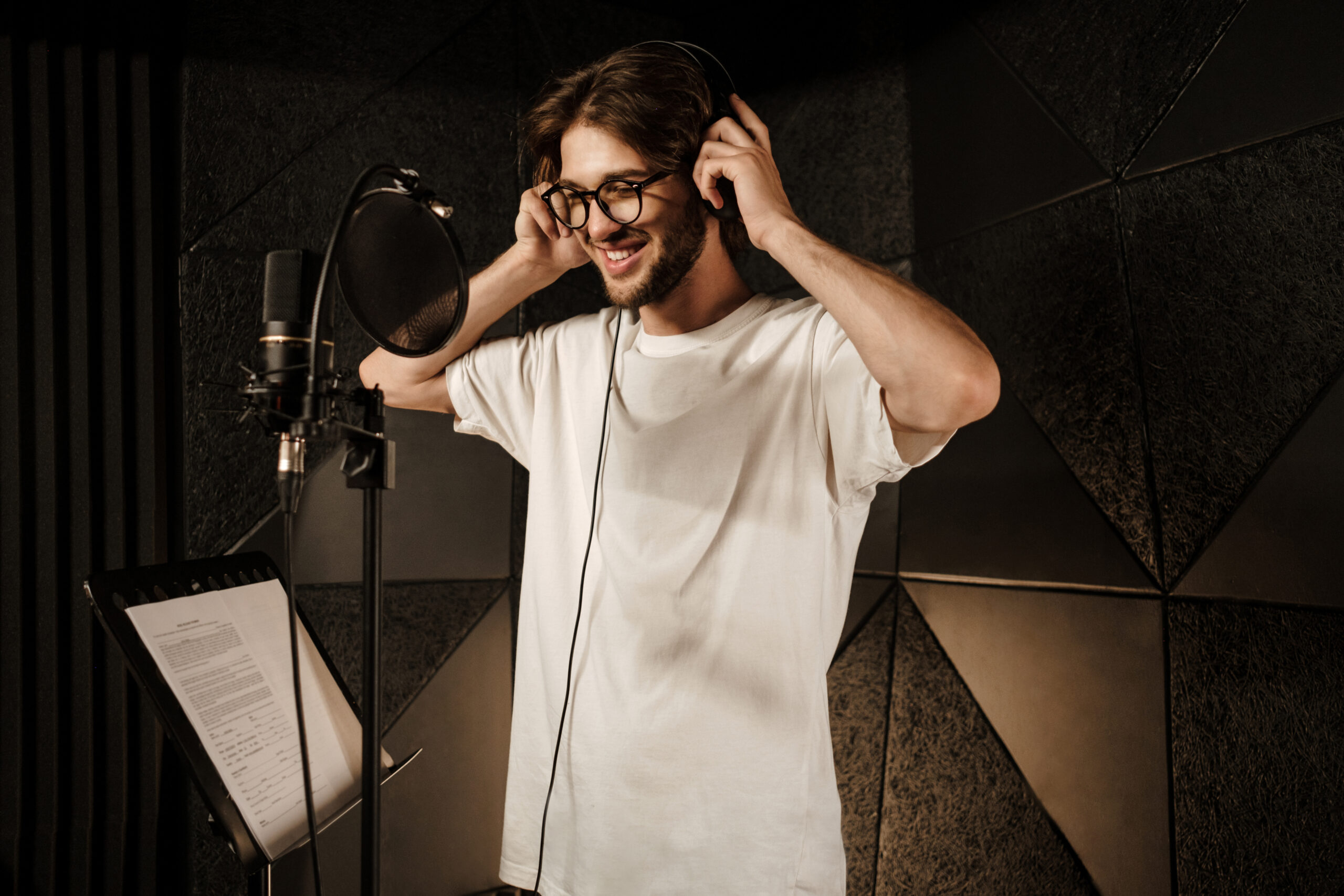 Voice over artist smiling and putting on headphones.